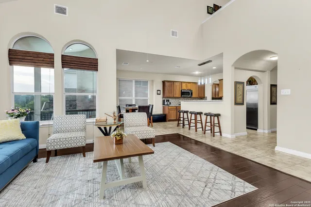 a living room with furniture a rug and a large window