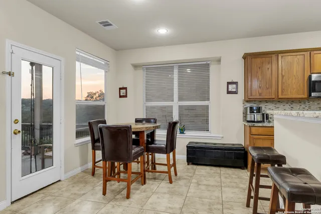 a view of a dining room with furniture and window