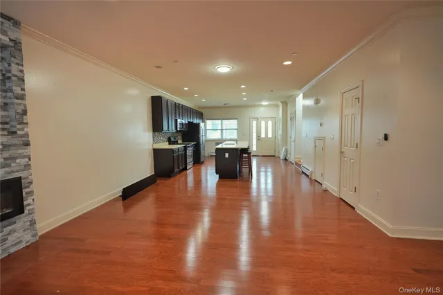 a view of a kitchen with furniture and wooden floor