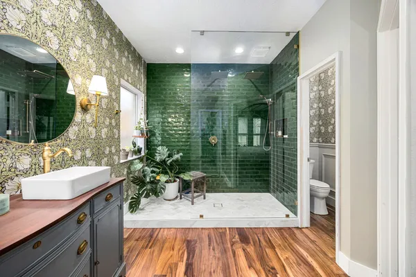 a bathroom with a sink mirror and shower