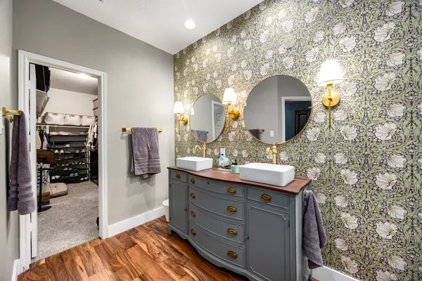a bathroom with a double vanity sink and a mirror