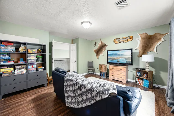 a bedroom with furniture and a flat screen tv