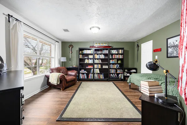 a living room with furniture window and bookshelf
