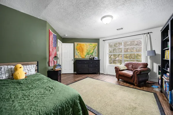 a bedroom with a bed and large window