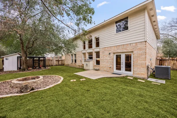 a view of a house with a yard and sitting area