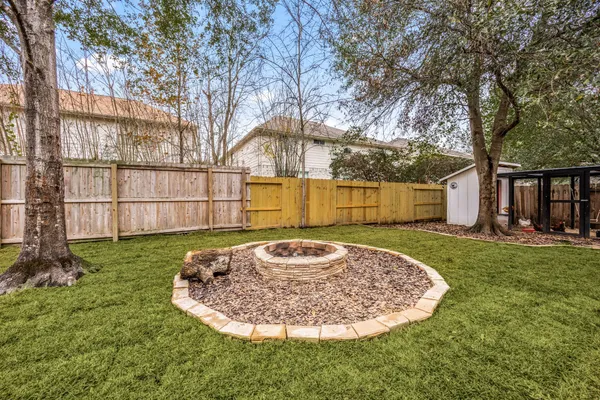 a view of a backyard with table and chairs