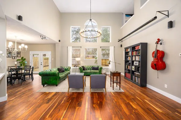 a view of a dining room with furniture wooden floor and chandelier