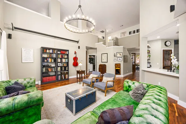 a living room with fireplace furniture and a chandelier