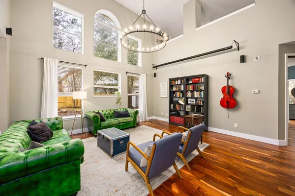 a living room with furniture flowerpot and a chandelier