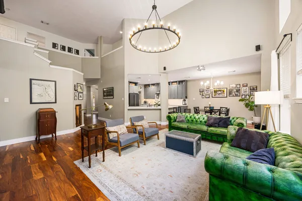 a living room with furniture and a chandelier