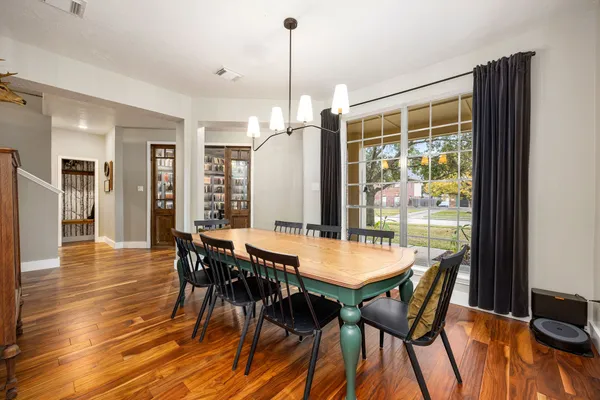 a view of a dining room with furniture window and wooden floor