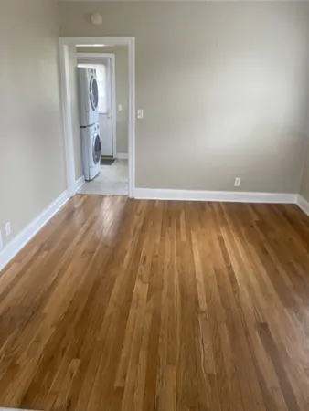 a view of a room with wooden floor and bench