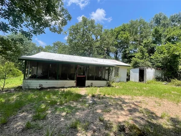 a view of a house with a yard and sitting area