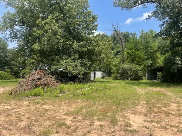 a backyard of a house with lots of green space and garden