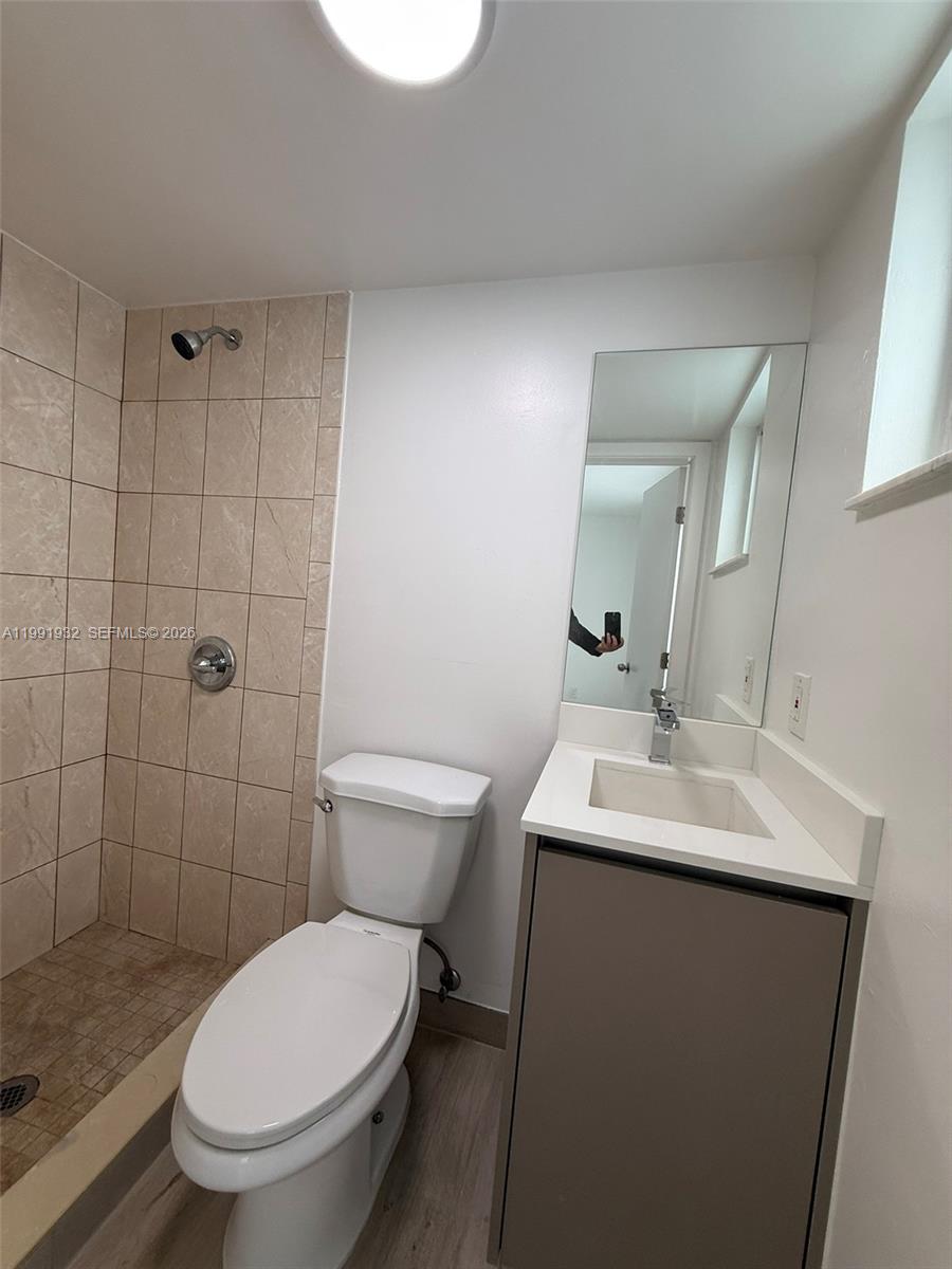 7251 Southwest 82nd Street, Unit 15 Miami, FL 33143 - Photo 11 of 15 a bathroom with a toilet sink shower and mirror