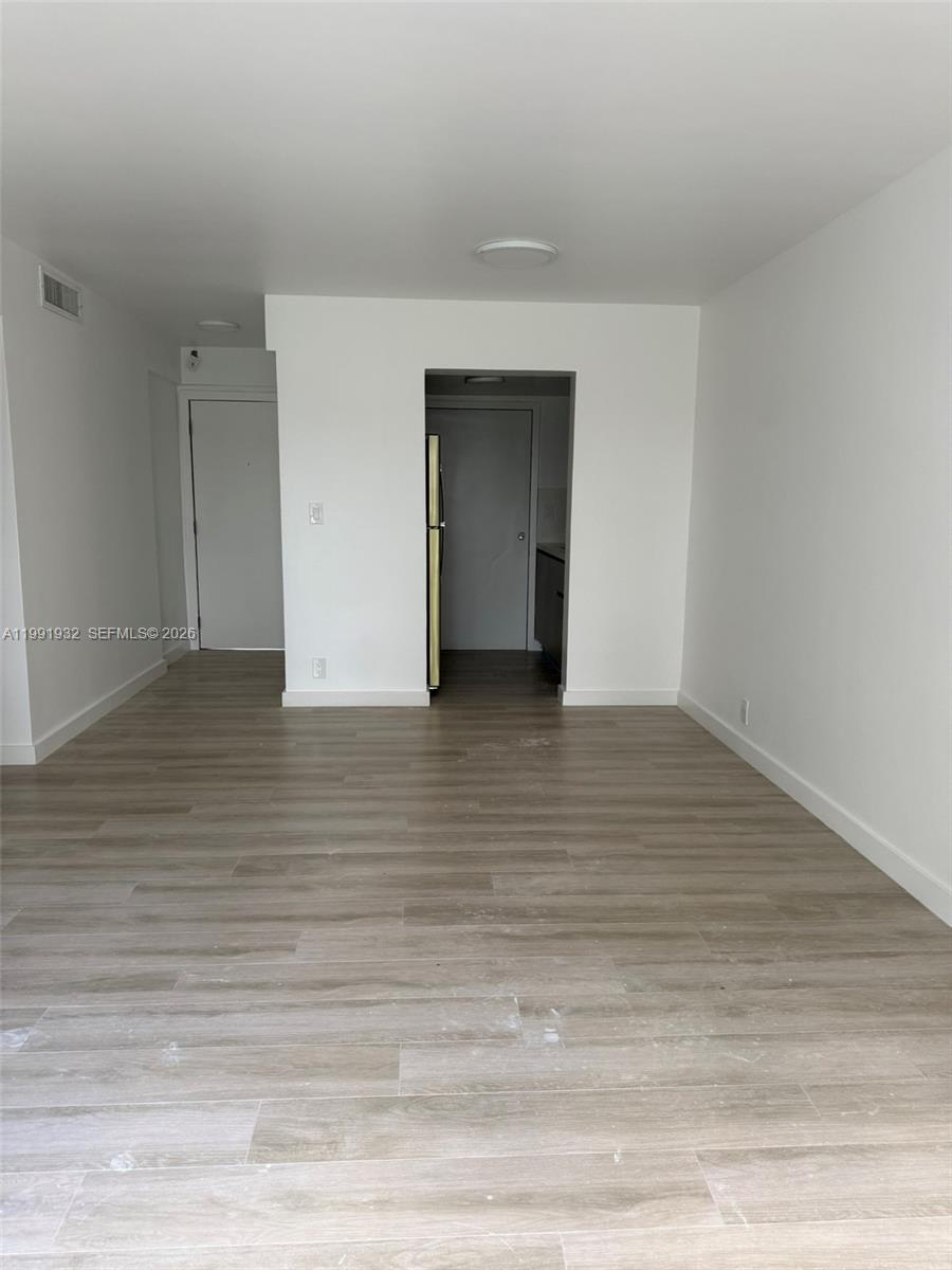 7251 Southwest 82nd Street, Unit 15 Miami, FL 33143 - Photo 2 of 15 a view of an empty room with wooden floor