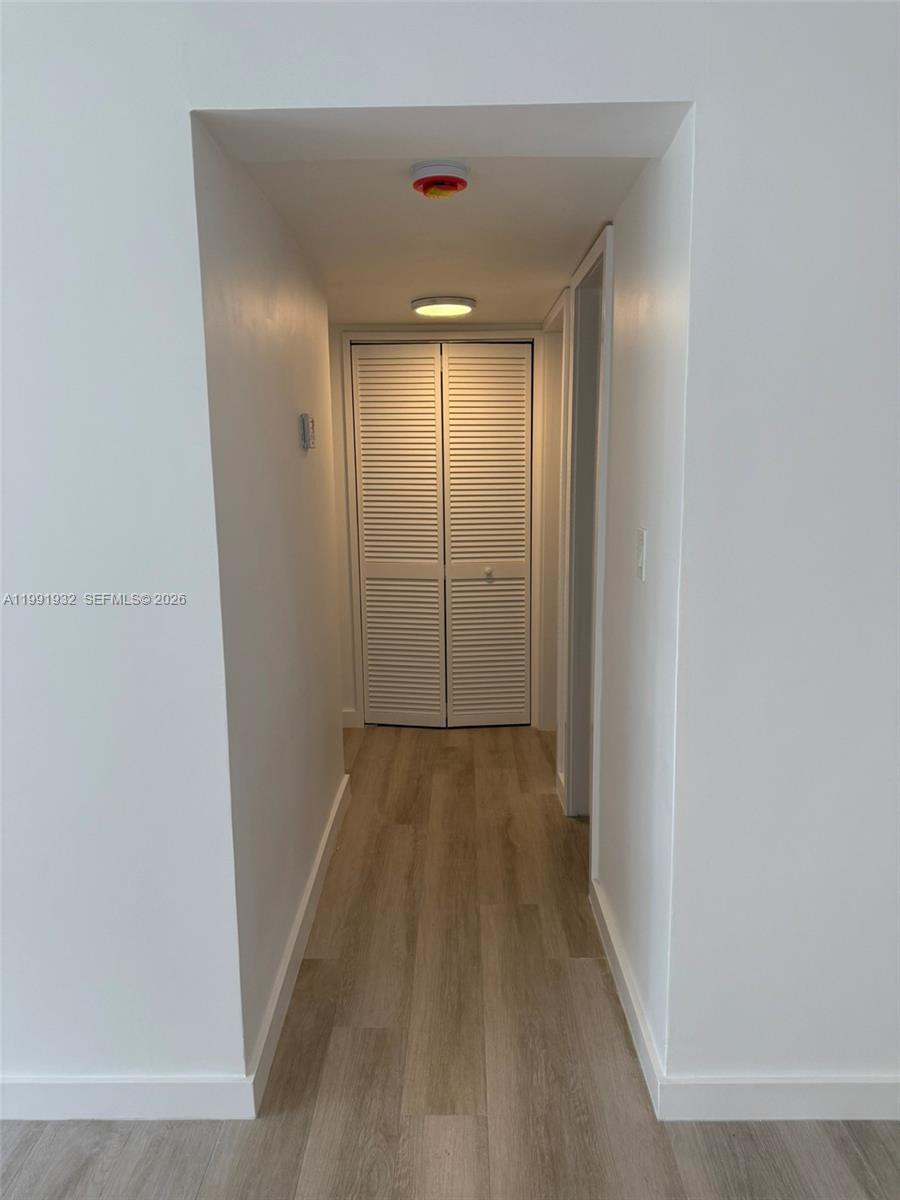 7251 Southwest 82nd Street, Unit 15 Miami, FL 33143 - Photo 5 of 15 a view of a hallway with wooden floor