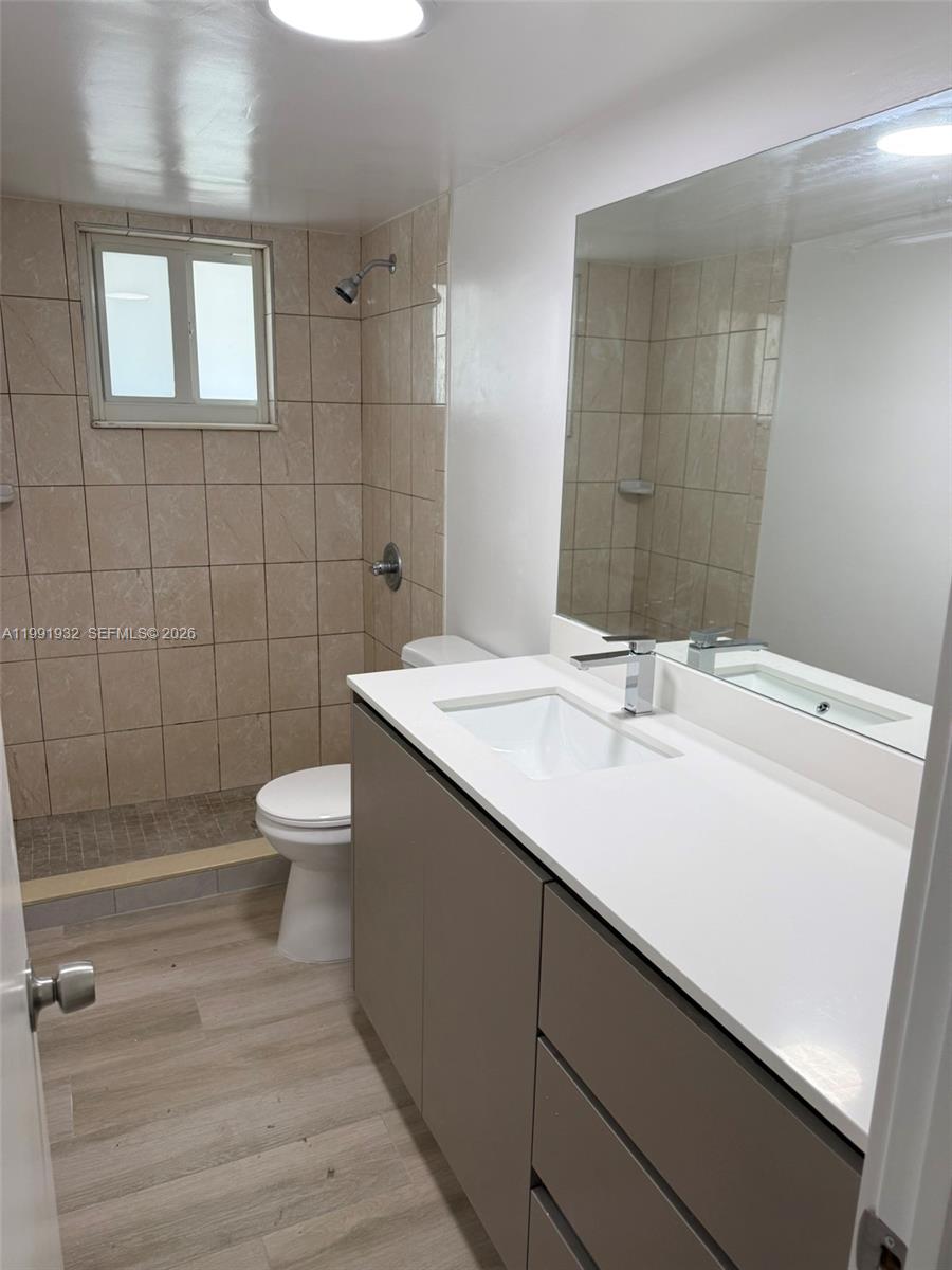 7251 Southwest 82nd Street, Unit 15 Miami, FL 33143 - Photo 6 of 15 a bathroom with a sink toilet and shower