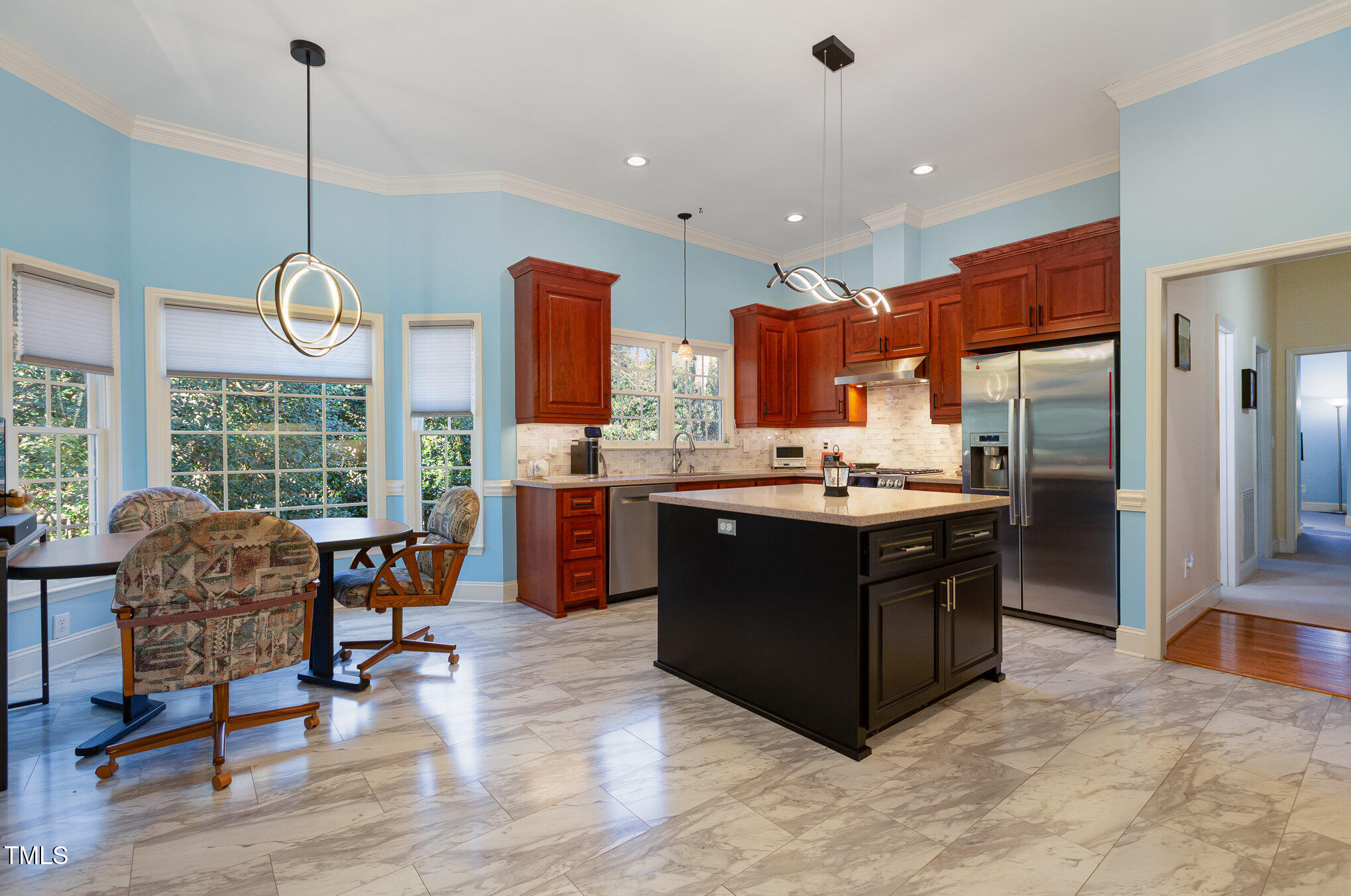 1508 High Holly Lane Raleigh, NC 27614 - Photo 16 of 46 a kitchen with stainless steel appliances granite countertop a stove a sink a oven a dining table and chairs with wooden floor