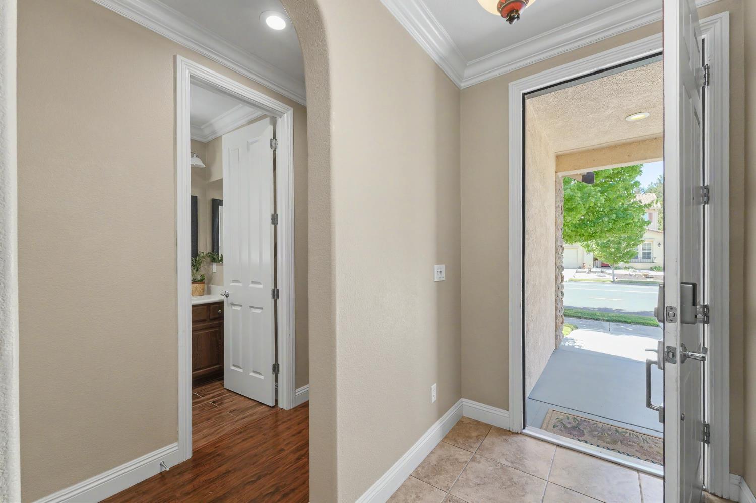 1223 East Springer Drive Turlock, CA 95382 - Photo 4 of 48 a view of a bathroom with a glass door and wooden floor