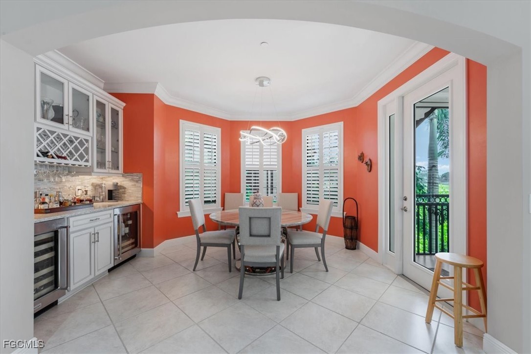 16432 Carrara Way, Unit 101 Naples, FL 34110 - Photo 12 of 50 a dining room with furniture and large windows