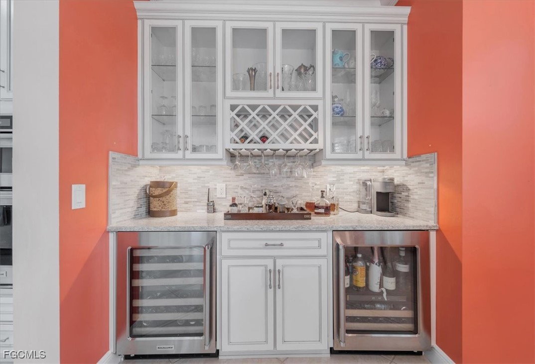 16432 Carrara Way, Unit 101 Naples, FL 34110 - Photo 13 of 50 a kitchen with granite countertop a sink and cabinets