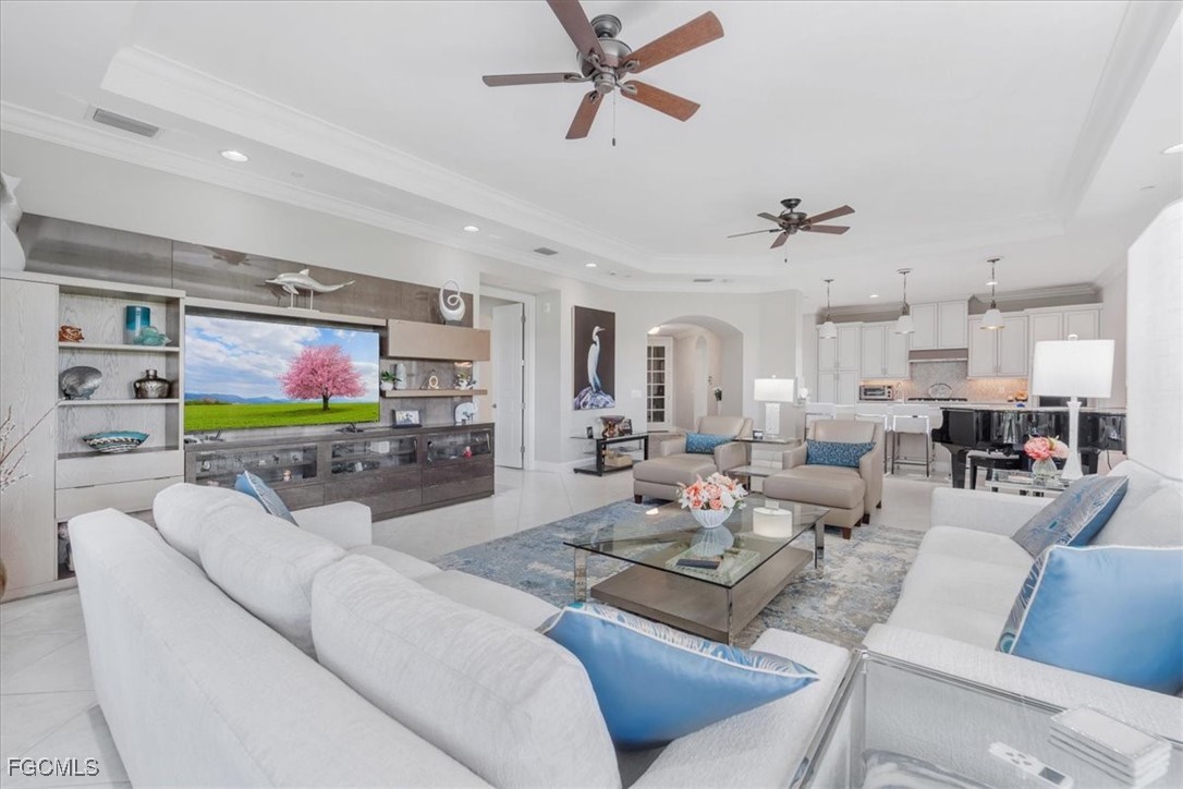 16432 Carrara Way, Unit 101 Naples, FL 34110 - Photo 20 of 50 a living room with furniture kitchen view and a flat screen tv