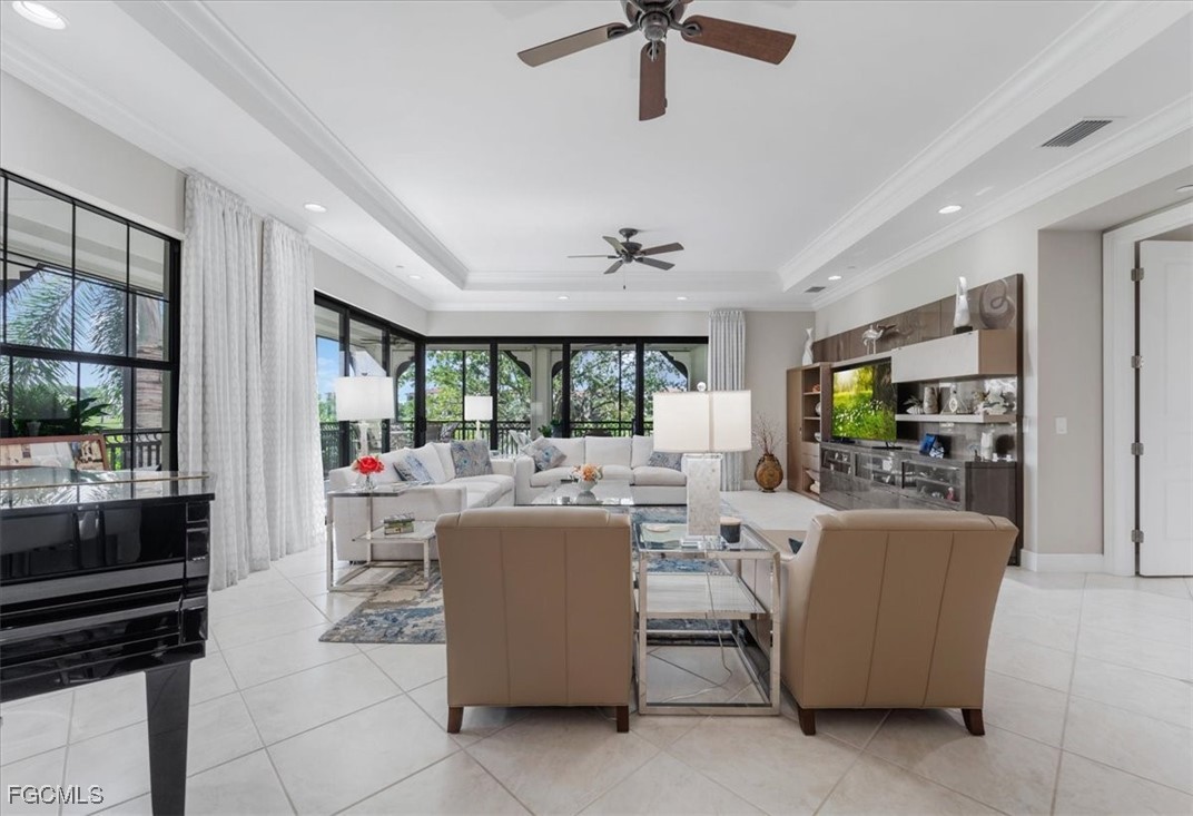 16432 Carrara Way, Unit 101 Naples, FL 34110 - Photo 22 of 50 a living room with furniture and a flat screen tv