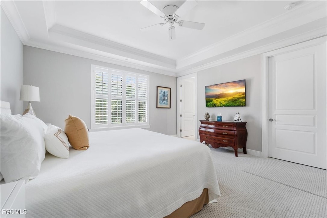 16432 Carrara Way, Unit 101 Naples, FL 34110 - Photo 27 of 50 a bedroom with a bed and a flat screen tv