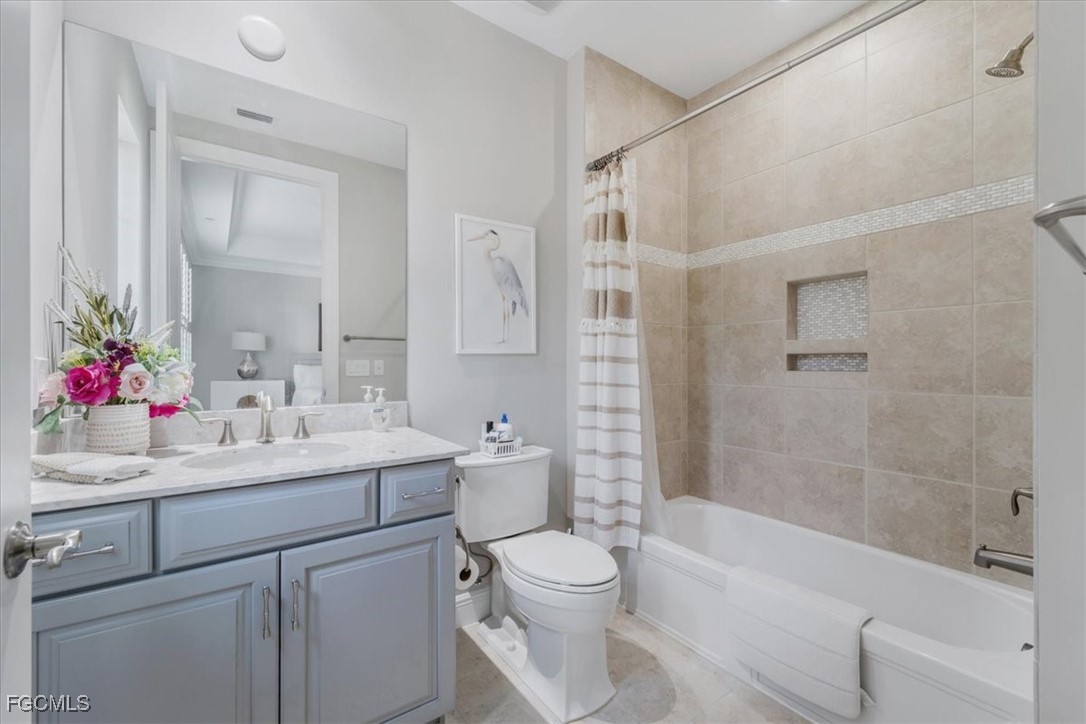 16432 Carrara Way, Unit 101 Naples, FL 34110 - Photo 28 of 50 a bathroom with a sink mirror toilet and bathtub