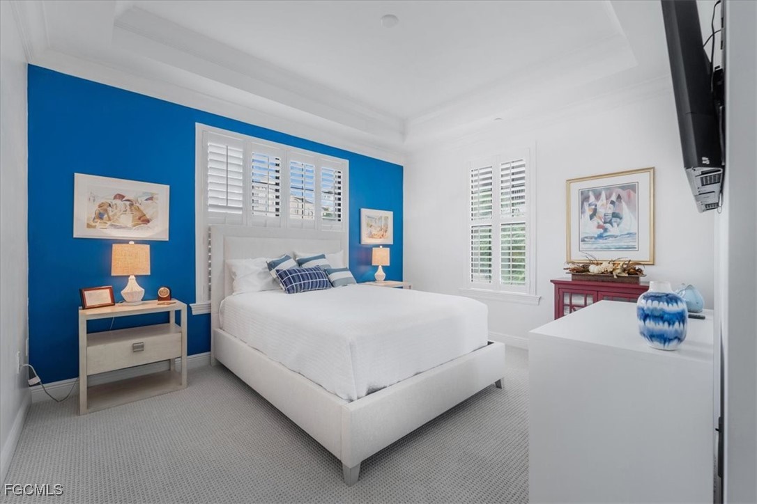 16432 Carrara Way, Unit 101 Naples, FL 34110 - Photo 29 of 50 a bed room with a bed and a desk