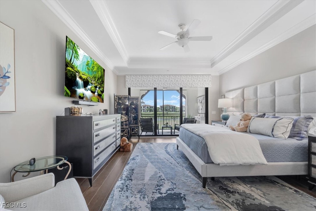 16432 Carrara Way, Unit 101 Naples, FL 34110 - Photo 33 of 50 a living room with furniture a flat screen tv and a large window