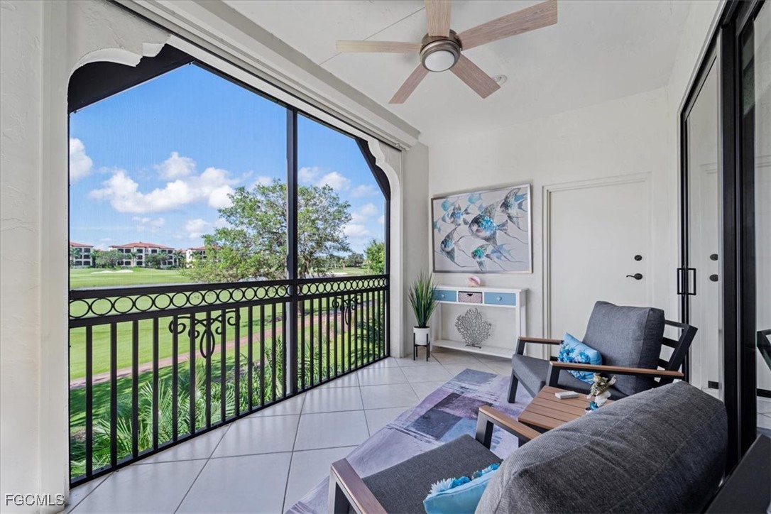 16432 Carrara Way, Unit 101 Naples, FL 34110 - Photo 43 of 50 a living room with furniture and a floor to ceiling window