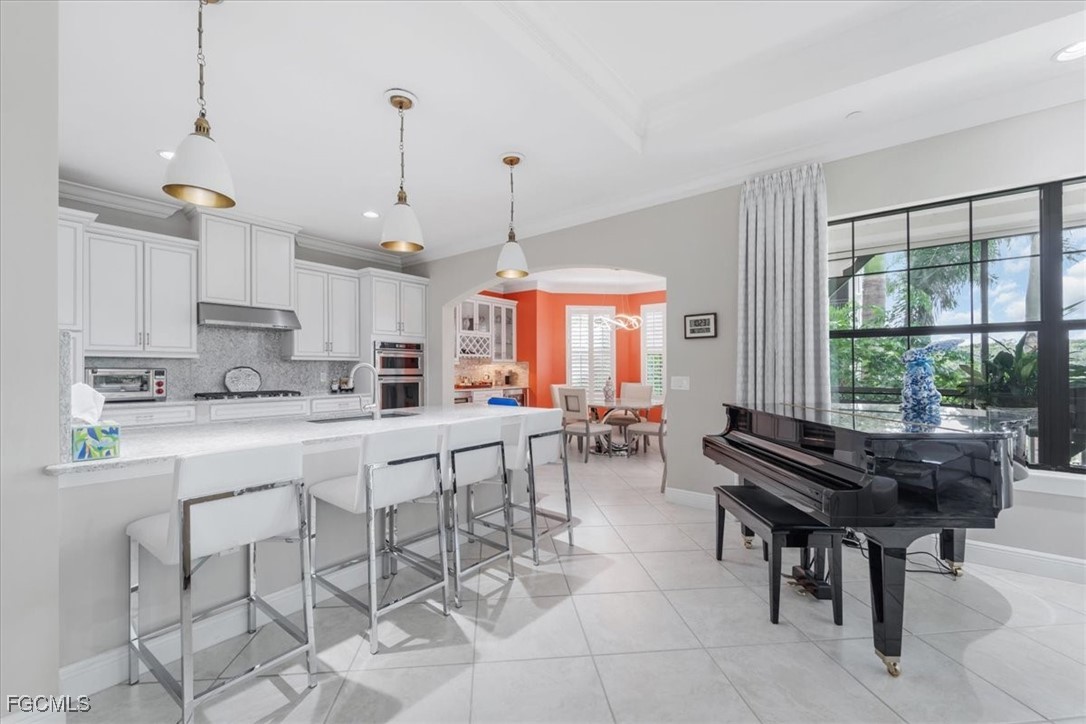 16432 Carrara Way, Unit 101 Naples, FL 34110 - Photo 5 of 50 a kitchen with stainless steel appliances kitchen island granite top and refrigerator