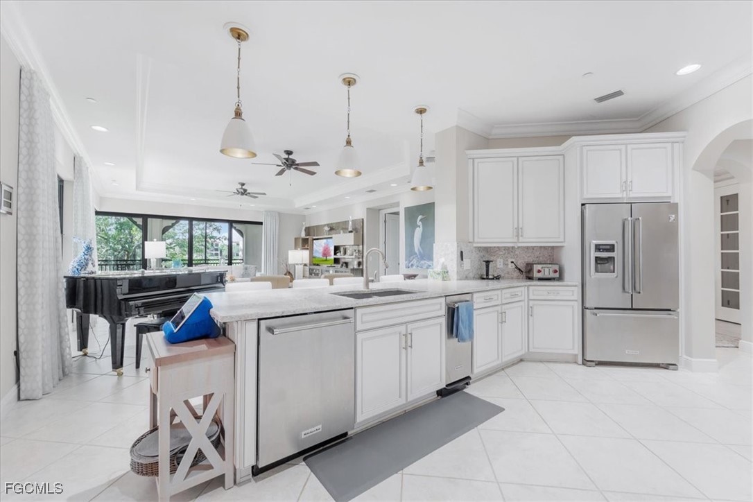 16432 Carrara Way, Unit 101 Naples, FL 34110 - Photo 10 of 50 a kitchen with white cabinets and white appliances