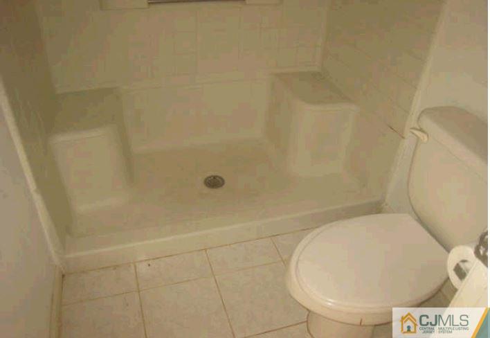 123 Edpas Road New Brunswick, NJ 08901 - Photo 9 of 9 a bathroom with a toilet and a shower