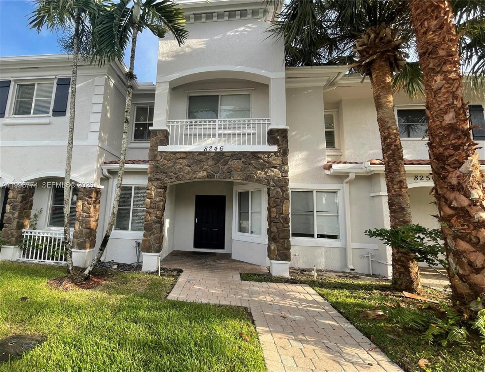 8246 Southwest 27th Street, Unit 103 Miramar, FL 33025 - Photo 1 of 17 a front view of a house with a yard garage and outdoor seating