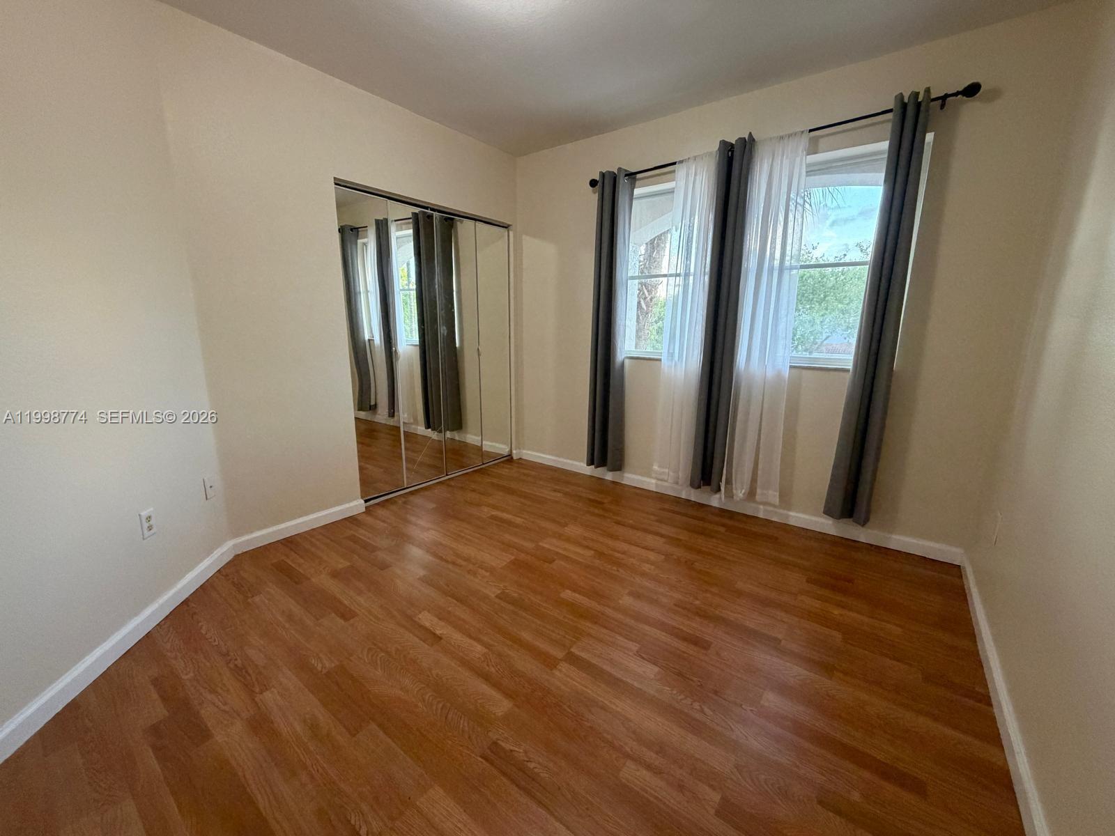 8246 Southwest 27th Street, Unit 103 Miramar, FL 33025 - Photo 17 of 17 a view of a room with wooden floor and windows