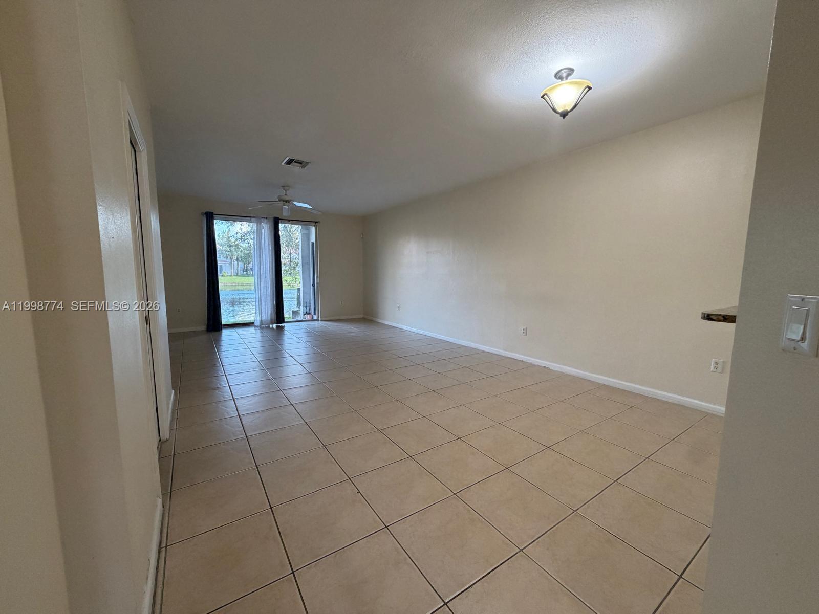 8246 Southwest 27th Street, Unit 103 Miramar, FL 33025 - Photo 7 of 17 an empty room with projector and a window
