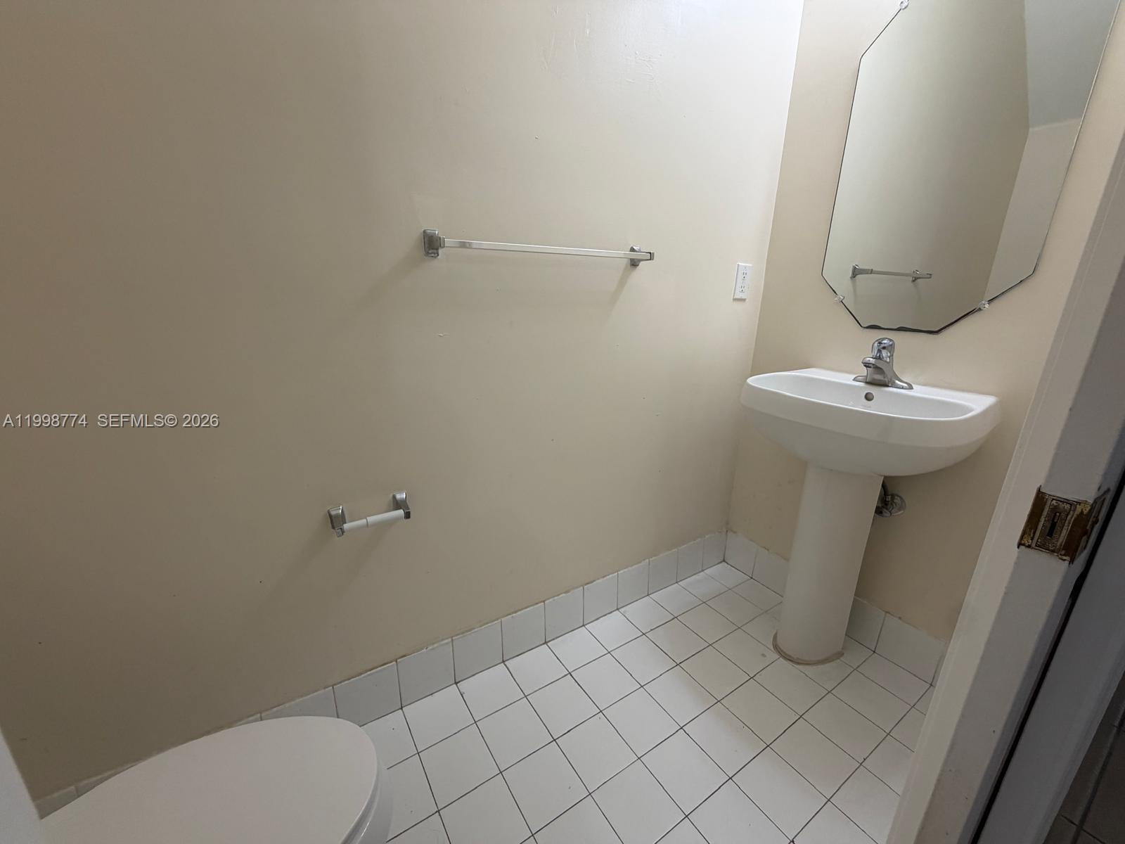 8246 Southwest 27th Street, Unit 103 Miramar, FL 33025 - Photo 9 of 17 a bathroom with a sink and toilet