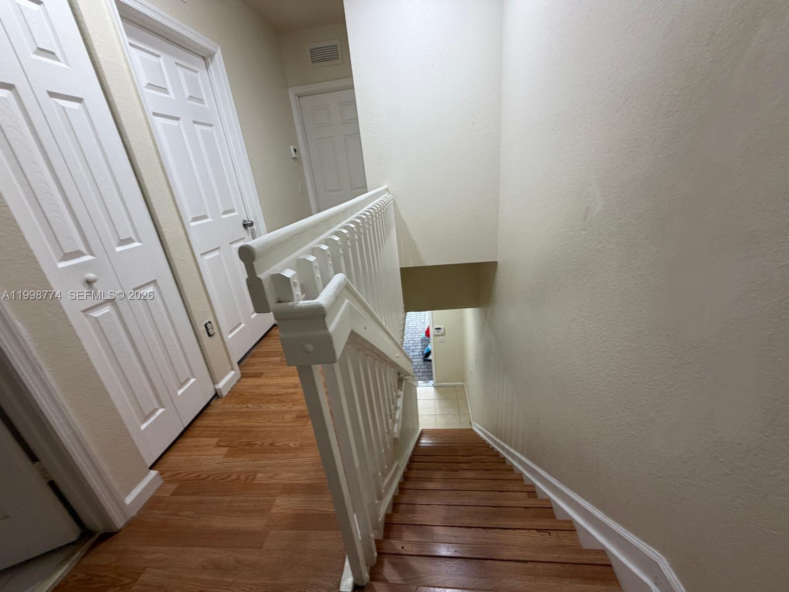 8246 Southwest 27th Street, Unit 103 Miramar, FL 33025 - Photo 10 of 17 a view of a hallway with wooden floor and staircase