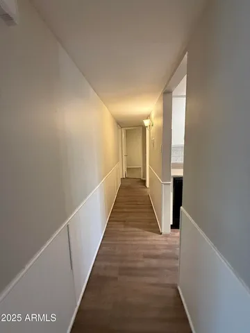 wooden floor in an empty room and a bathroom