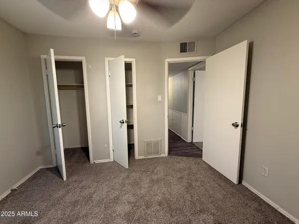 wooden floor in an empty room and a bathroom