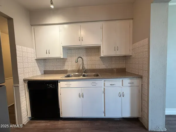 a kitchen with stainless steel appliances granite countertop a sink and cabinets