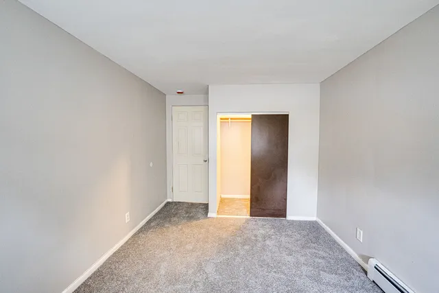 a view of an empty room and closet area