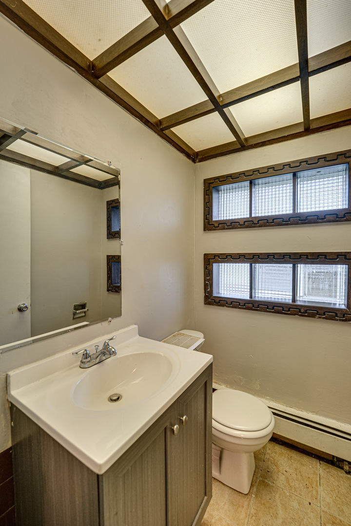 3235 West 157th Street Markham, IL 60428 - Photo 3 of 21 a bathroom with a sink and a toilet