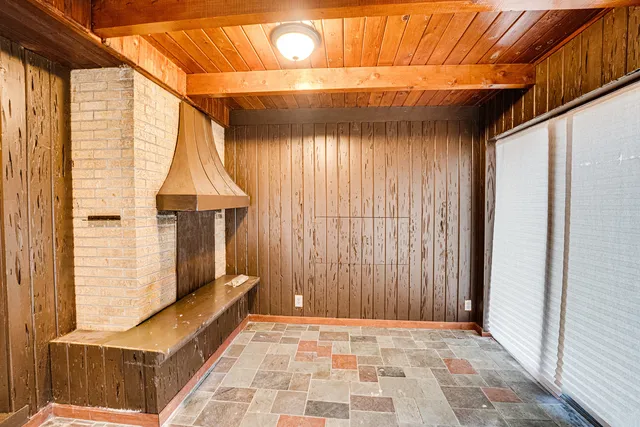 a backyard of a house with wooden floor and outdoor seating