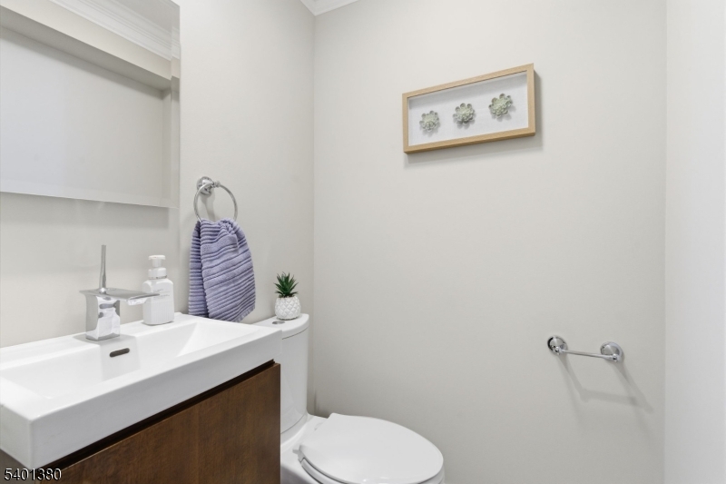 107 Chestnut Street Bound Brook, NJ 08805 - Photo 12 of 24 a bathroom with a toilet sink and mirror