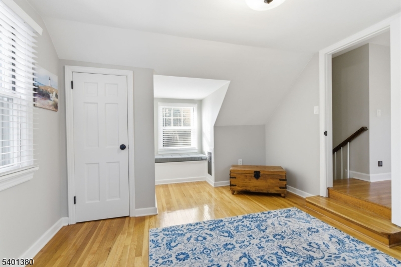107 Chestnut Street Bound Brook, NJ 08805 - Photo 14 of 24 a bedroom with a bed and wooden floor