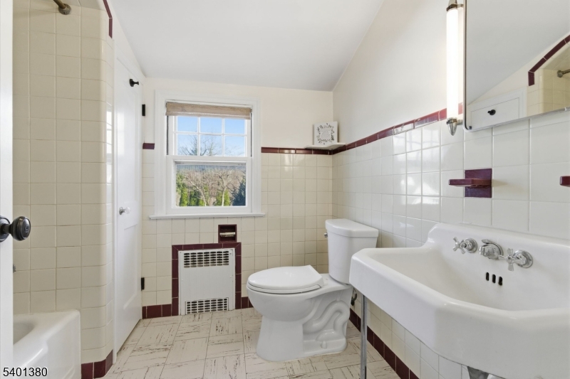 107 Chestnut Street Bound Brook, NJ 08805 - Photo 16 of 24 a bathroom with a sink a toilet and shower